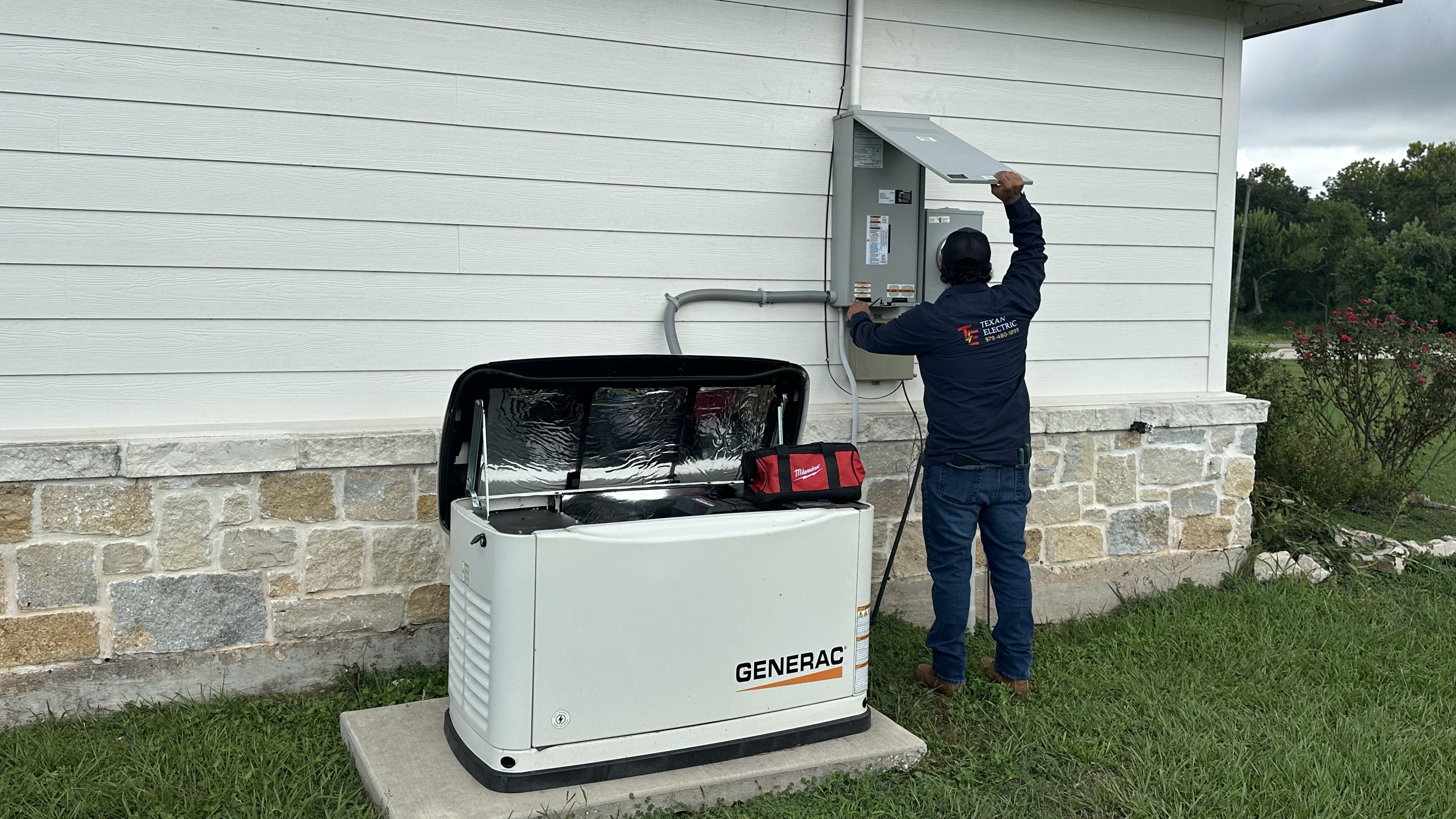 Texan Electric employee working beside a Generac standby generator